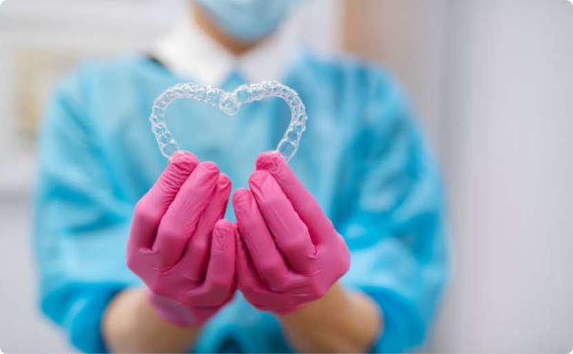 Lake Superior Dental Staff holding two mouthguards in heart shape